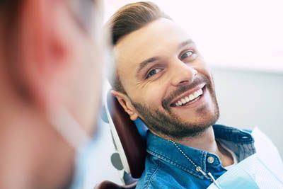 man smiling during his teeth whitening appointment at North Atlanta Family Dentistry