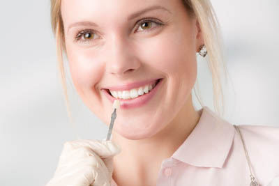 woman choosing color for dental veneers at North Atlanta Family Dentistry