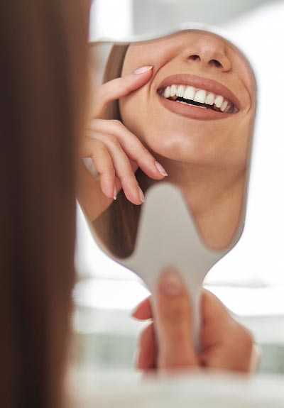 woman smiling in a mirror