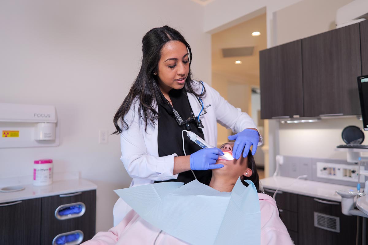 dentist taking 3d imaging of female patient's mouth