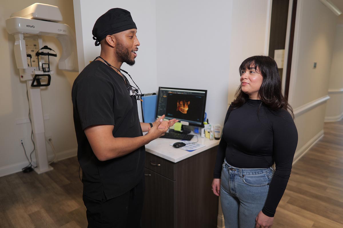 dentist speaking to female patient about dental technologies