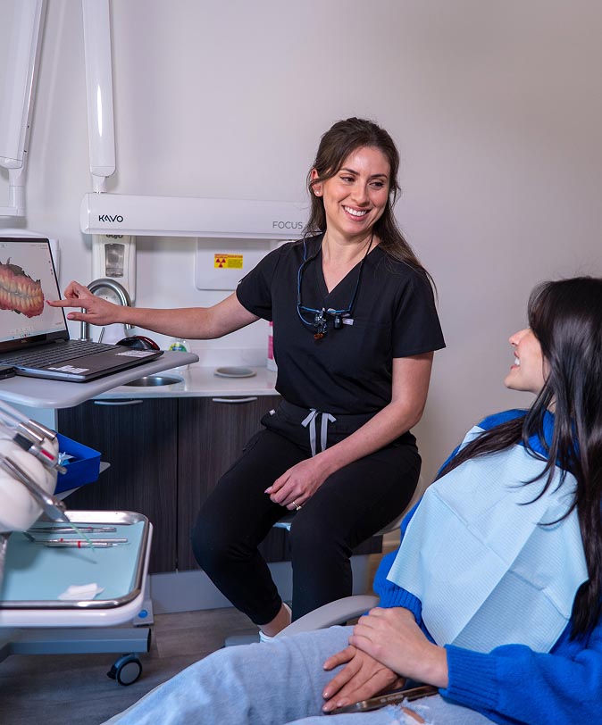 dentist showing female patient her dental scans